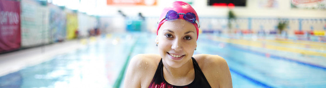 Girl with pink swimming cap smiling